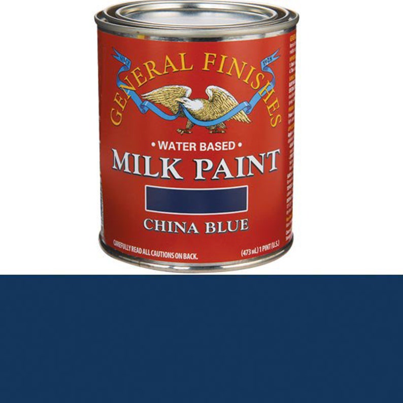 May include: A can of General Finishes Milk Paint in China Blue. The can is red with white lettering and a blue eagle logo. The can is labeled "Water Based" and "Milk Paint".