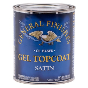 May include: A blue can of General Finishes Gel Topcoat Satin oil-based finish. The can has a red, white, and blue eagle logo and the text "Since 1928". The can is labeled "Oil Based" and "Gel Topcoat Satin". The warning label reads "Combustible Liquid and Vapor. Causes Eye Irritation."