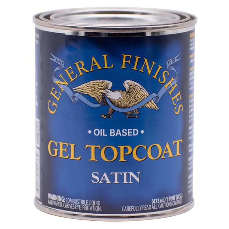 May include: A blue can of General Finishes Gel Topcoat Satin oil-based finish. The can has a red, white, and blue eagle logo and the text "Since 1928". The can is labeled "Oil Based" and "Gel Topcoat Satin". The warning label reads "Combustible Liquid and Vapor. Causes Eye Irritation."