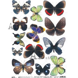 May include: A sheet of decoupage rice paper with a variety of colorful butterfly designs. The butterflies are in various sizes and positions, with some overlapping. The paper is white with a subtle texture.