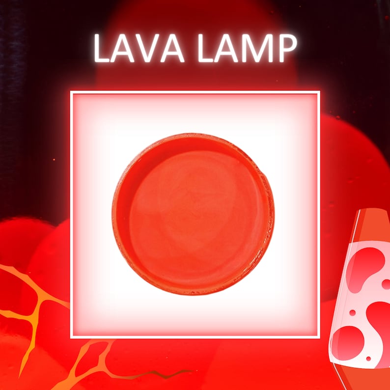 May include: A red lava lamp base, a circular ceramic piece with a smooth, glossy finish.