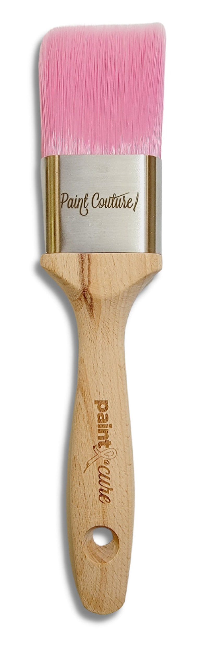 May include: A pink angled paint brush with a wooden handle. The handle has the words "Paint Couture" engraved on it.