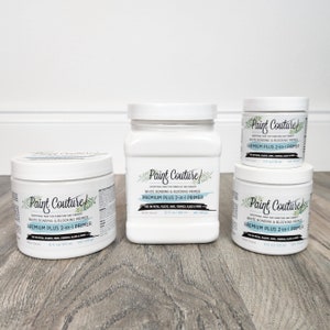May include: Four white bottles of Paint Couture white bonding and blocking primer. The bottles are labelled "Premium Plus 2-in-1 Primer" and are available in 8 oz, 16 oz, and 32 oz sizes.
