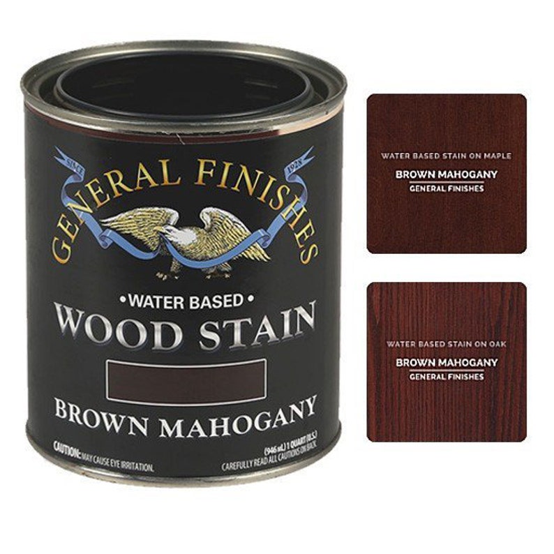 May include: A can of General Finishes water-based wood stain in the color Brown Mahogany. The can is black with a gold eagle logo and the text "General Finishes" in a gold circle. The can is labeled "Water Based Wood Stain" and "Brown Mahogany".