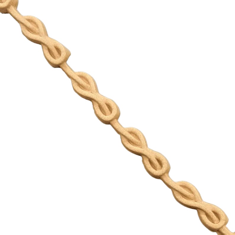 May include: A wooden trim molding with a repeating knot design. The molding is a light brown color and has a smooth finish.