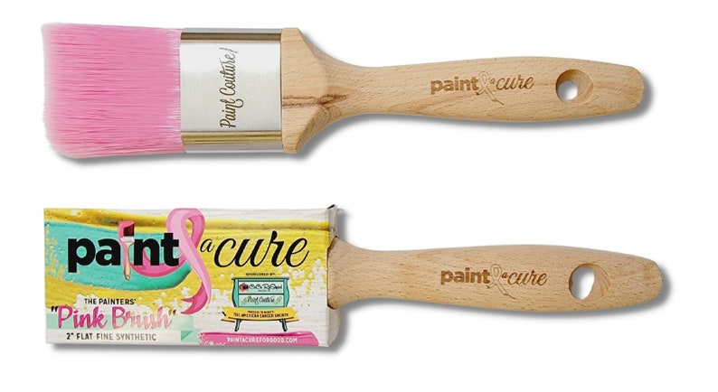 May include: Two paint brushes with wooden handles. The larger brush has pink bristles and the smaller brush has a pink ribbon on the handle. Both brushes have the text "paint a cure" on the handle. The smaller brush is packaged in a box with the text "The Painters "Pink Brush" 2" Flat Fine Synthetic" and "paintacureforgood.com".