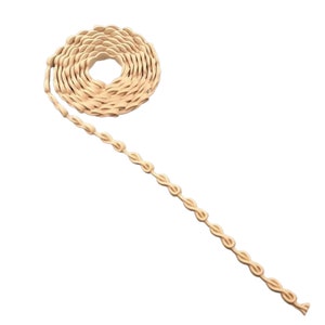 May include: A beige, looped trim with a decorative chain-like pattern. The trim is coiled into a circle and a long strand is extending from the coil.