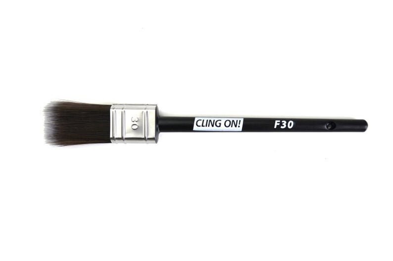 May include: A black paint brush with a silver ferrule and black handle. The handle has the text "CLING ON!" and "F30" printed on it.