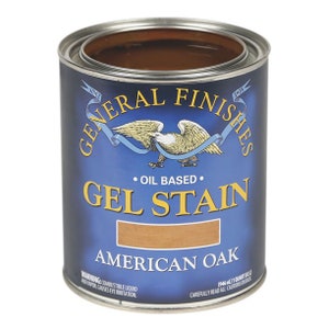 May include: A can of General Finishes Gel Stain in American Oak. The can is blue with a white eagle logo and the text "Oil Based" and "Gel Stain" in white. The can is labeled with the color "American Oak".