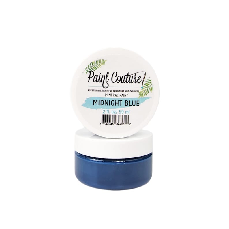 May include: A small jar of Midnight Blue mineral paint by Paint Couture. The jar is labeled with the brand name, paint type, and color. The jar contains 2 fluid ounces or 59 milliliters of paint.