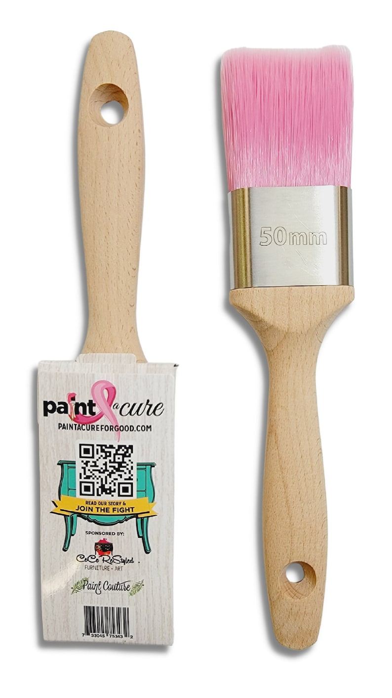 May include: A pink paint brush with a wooden handle and a silver ferrule. The brush is 50mm wide. The brush is packaged with a card that says "paint cure" and has a QR code. The card also says "PaintACureForGood.com" and "Read our story & join the fight". The card is sponsored by "CoCo ReStyled" and "Paint Couture".