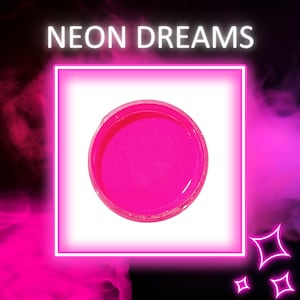 May include: A small round container of bright pink neon slime. The container is sitting on a white background.
