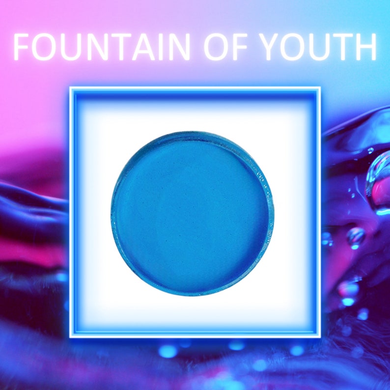 May include: A round, bright blue eyeshadow compact. The compact is isolated on a white background.