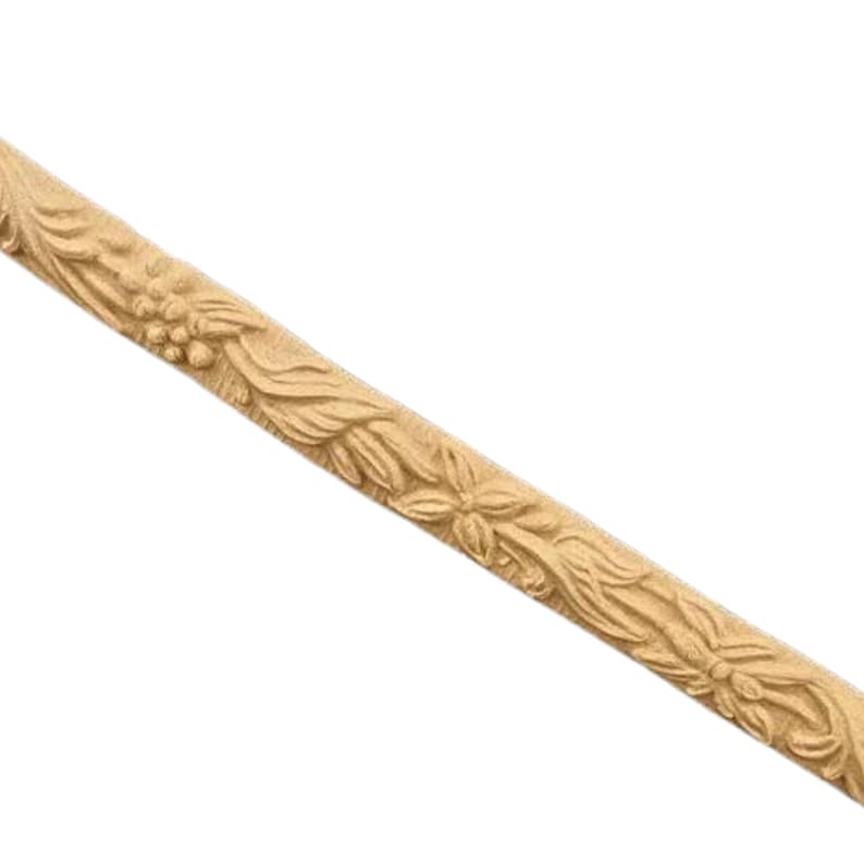 May include: A wooden trim molding with a carved floral design. The trim is light brown and has a smooth finish.