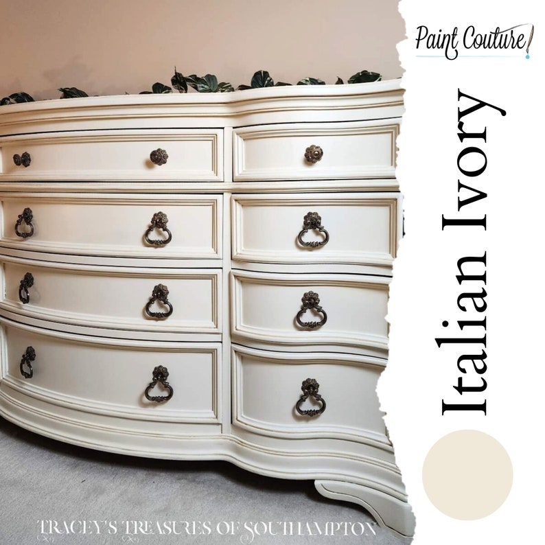 May include: A white dresser with a curved front and ornate brass hardware. The dresser has six drawers and is painted in a colour called "Italian Ivory".