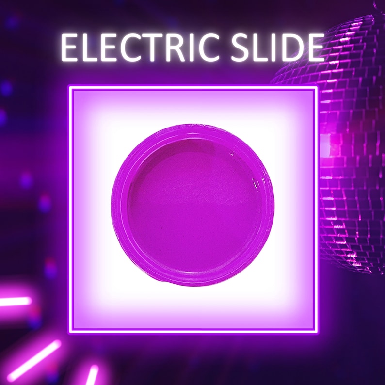 May include: A small, round container of bright purple glitter. The container is on a white background with a neon pink border.