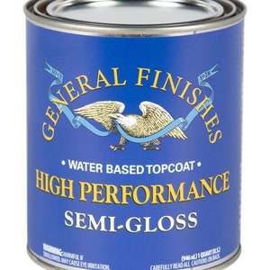 May include: A blue can of General Finishes High Performance Semi-Gloss water-based topcoat. The can features an eagle with a ribbon and the text "Since 1928". The can is labeled with a warning that the product is harmful if swallowed and may cause eye irritation.