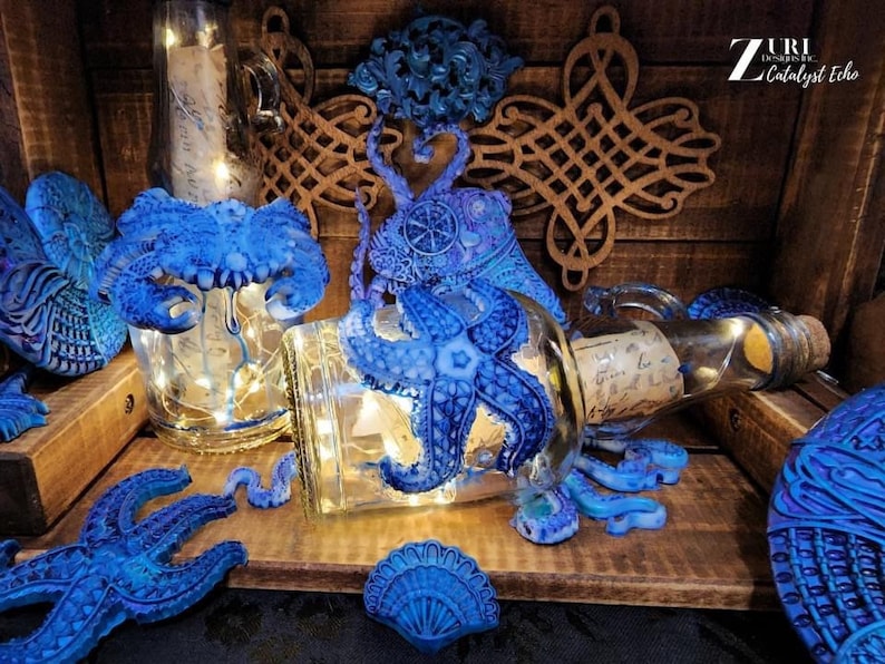 May include: A collection of blue glass bottles with a variety of sea-themed decorations, including an octopus, starfish, and seashells. The bottles are lit from within, creating a warm glow. The bottles are arranged on a wooden surface.