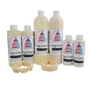 May include: An assortment of flexible casting resin products by Paint Couture. The set includes bottles of Step 1 and Step 2 resin, along with decorative ivory-colored resin bracelets. The bottles have labels with a Capitol building logo.