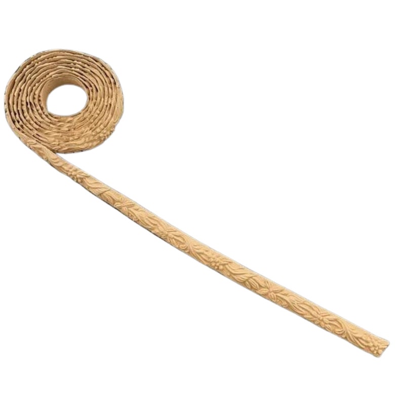 May include: A roll of beige decorative trim with a floral pattern. The trim is coiled and has a long length extending from the coil.