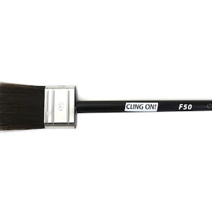 May include: A black and silver paint brush with a black handle and the text "CLING ON! F50" printed on the handle.