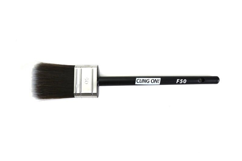 May include: A black and silver paint brush with a black handle and the text "CLING ON! F50" printed on the handle.