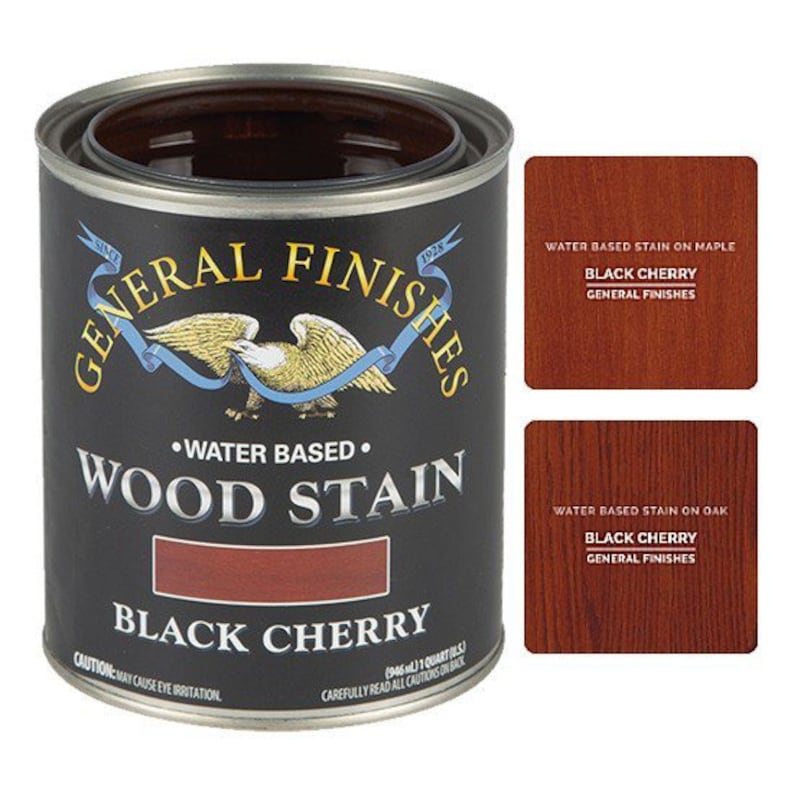 May include: A can of General Finishes water-based wood stain in the color Black Cherry. The can is black with a gold eagle logo and the text "General Finishes" and "Wood Stain" in white. The can also shows a sample of the stain color.