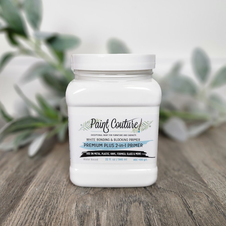 May include: A white plastic jar of Paint Couture Premium Plus 2-in-1 Primer. The jar is labelled "Exceptional Paint for Furniture and Cabinets" and "White Bonding & Blocking Primer". The jar is 32 fl oz / 946 ml and has a low VOC content.