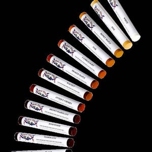 May include: A set of 12 wood stain markers in various shades, including black, mahogany, rosewood, brown mahogany, antique cherry, walnut, shaker maple, candlelight, oak, honey maple, pine, and white. The markers are labeled "General Finishes" and are designed for minor restoration of scratches.