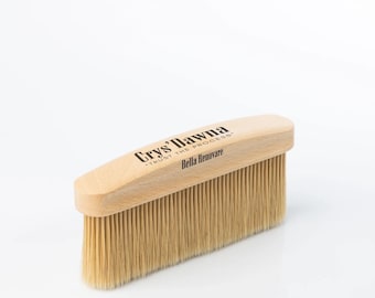 May include: A wooden brush with natural bristles. The handle is labeled "Crys' Dawna" and "Trust the Process" with the text "Bella Renovare" below.