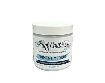 May include: A white jar of Paint Couture Pigment Medium, a water-based paint for furniture and cabinets. The jar is labeled with the brand name and product name, and it contains 4 fluid ounces (118 ml).