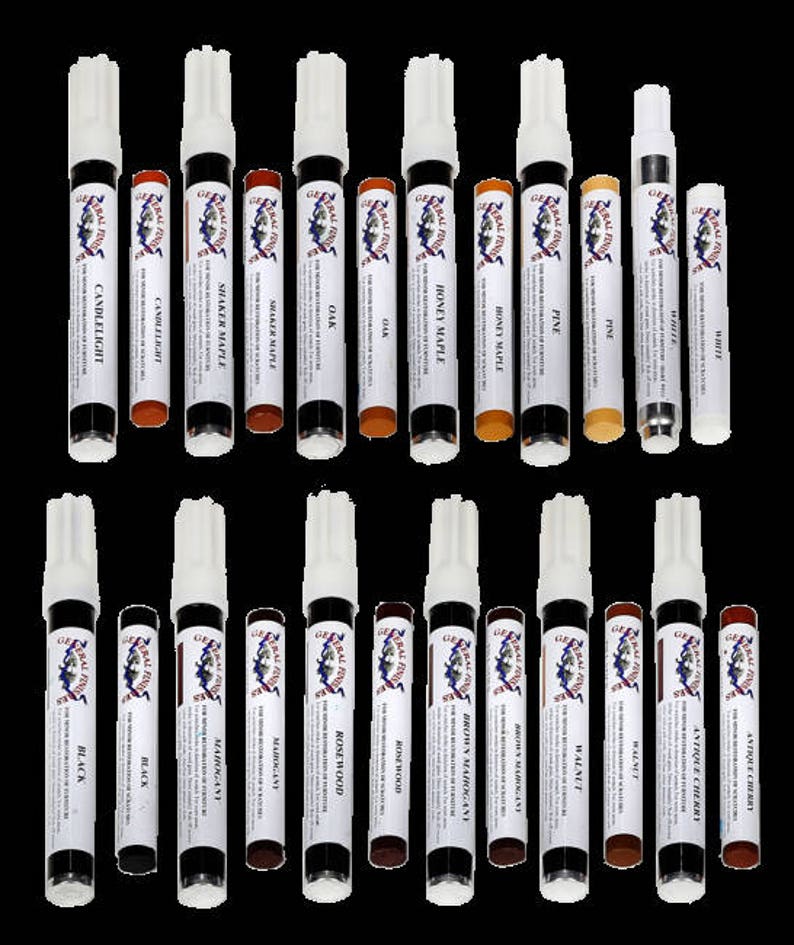 May include: A set of 20 wood stain markers in various colors, including Candlelight, Shaker Maple, Oak, Honey Maple, Pine, White, Black, Mahogany, Rosewood, Brown Mahogany, Walnut, Antique Cherry, and more. The markers are labeled with the wood stain color and the General Finishes logo.