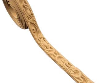 May include: A roll of light brown decorative trim with an intricate, carved floral design. The trim is curled at one end, revealing the layered edges. The detailed carving adds a touch of elegance and sophistication to any craft or design project.