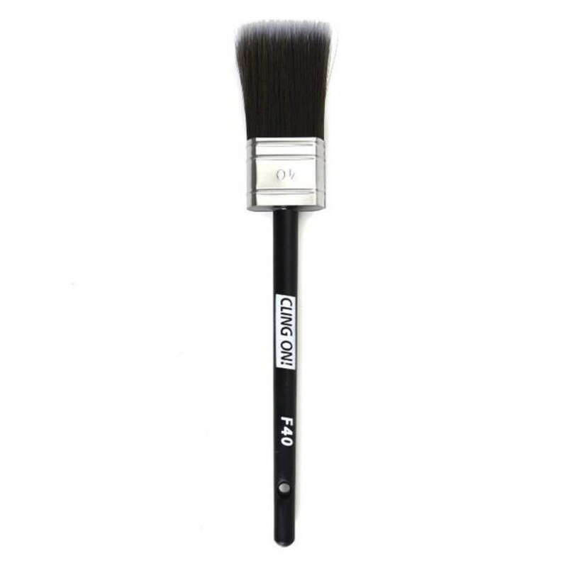 May include: A black paint brush with a silver ferrule and black handle. The handle has the text "CLING ON!" and "F40" printed on it.