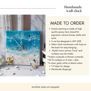 May include: Handmade wall clock with a blue ocean scene, white sand, and seashells. The clock face has silver hands and Roman numerals. The clock is made to order and can be customized with different sizes, colors, and number styles.