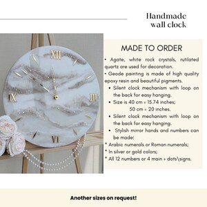May include: Handmade wall clock with a geode design. The clock features gold-colored Roman numerals and hands, set against a white and beige marbled background. The clock is 20 inches in diameter.