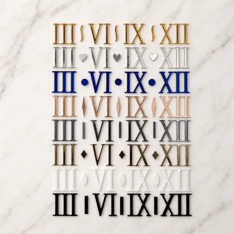 Peut inclure: Plusieurs num&eacute;ros de table en chiffres romains de diff&eacute;rentes couleurs, dont l'or, l'argent, le bleu et le noir. Les chiffres sont dispos&eacute;s en rang&eacute;es et en colonnes, chaque rang&eacute;e pr&eacute;sentant un style et une couleur diff&eacute;rents.