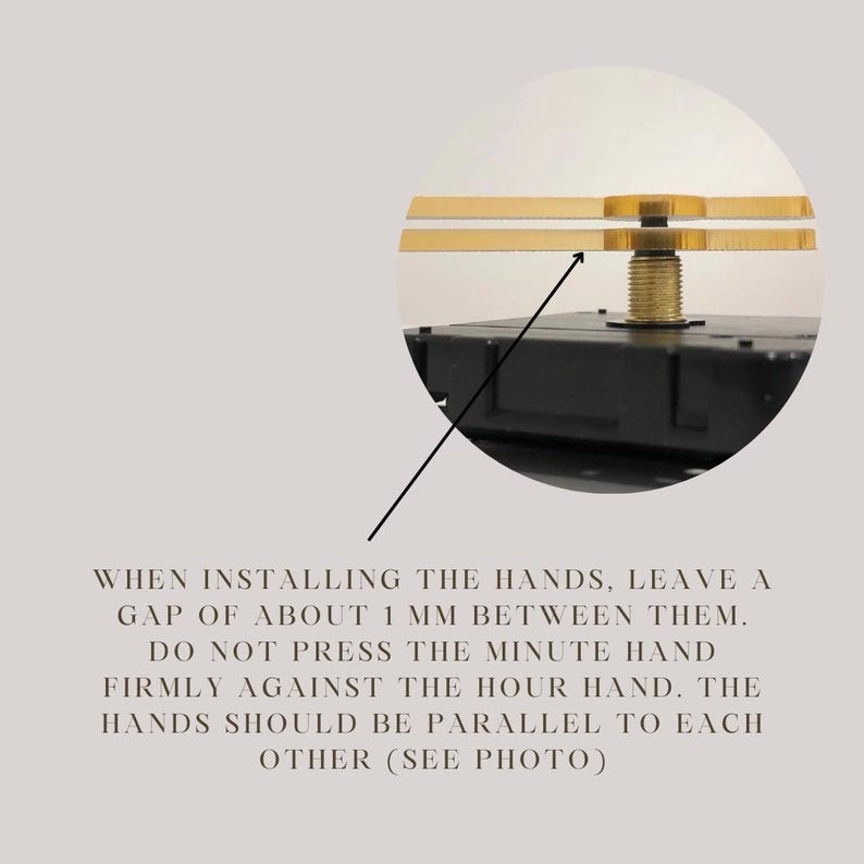 May include: Close-up of a clock mechanism with two gold hands. The hands are positioned to show a 1 mm gap between them. The text reads: "WHEN INSTALLING THE HANDS, LEAVE A GAP OF ABOUT 1 MM BETWEEN THEM. DO NOT PRESS THE MINUTE HAND FIRMLY AGAINST THE HOUR HAND. THE HANDS SHOULD BE PARALLEL TO EACH OTHER (SEE PHOTO)"