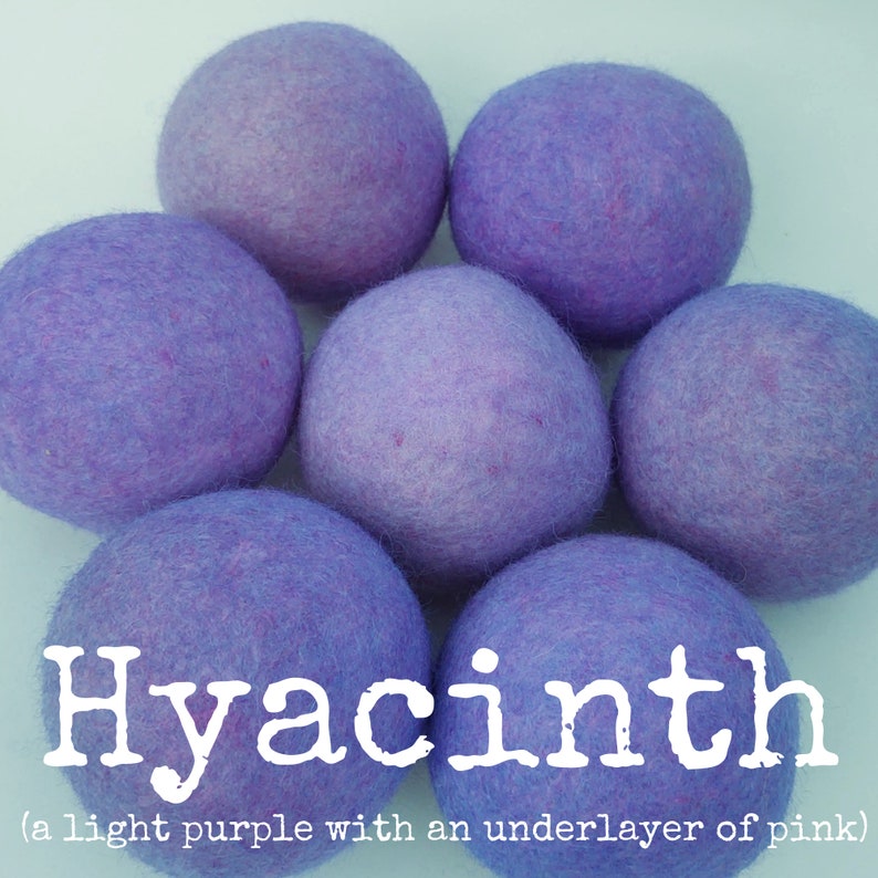 May include: Hyacinth wool dryer balls, a light purple with an underlayer of pink. These balls are a natural alternative to dryer sheets and help to soften clothes and reduce drying time.