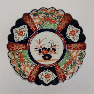 Antique Japanese Imari porcelain plate in blue and red with motifs of landscape and flower basket 1900s Large antique Chinese wall plate