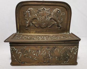 Antique copper candle box with hammered decoration coat of arms lions and Dutch scene with cows  and farm 19th century Antique candle box