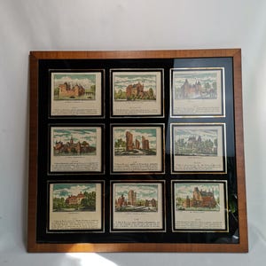 May include: A framed collection of nine antique prints depicting various castles and buildings. Each print features a detailed illustration with accompanying text in Dutch. The prints are arranged in a grid pattern within a wooden frame.