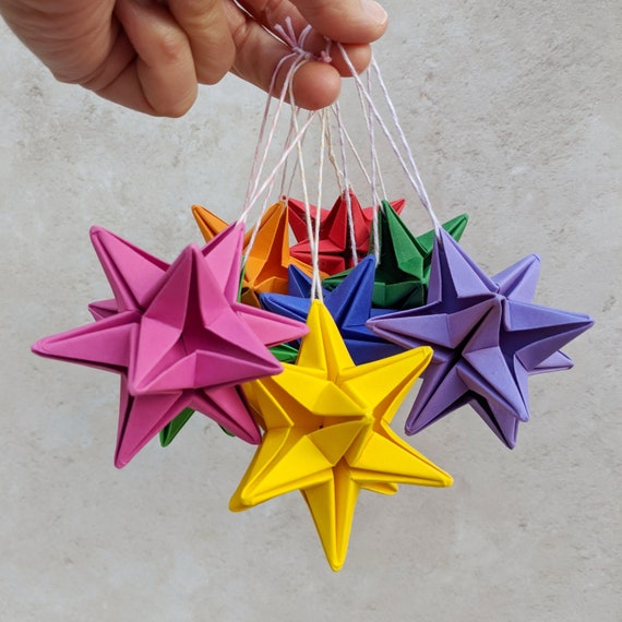 Brightly colored origami paper stars on black back