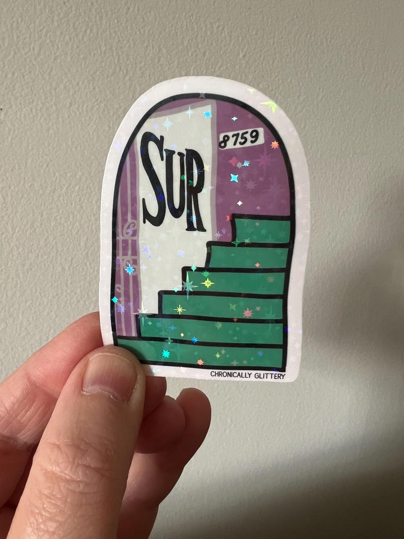 May include: A sticker with a glittery finish featuring a green staircase leading to a purple door with the word "SUR" on it. The door has a white number "8759" above it. The sticker has the text "CHRONICALLY GLITTERY" at the bottom.