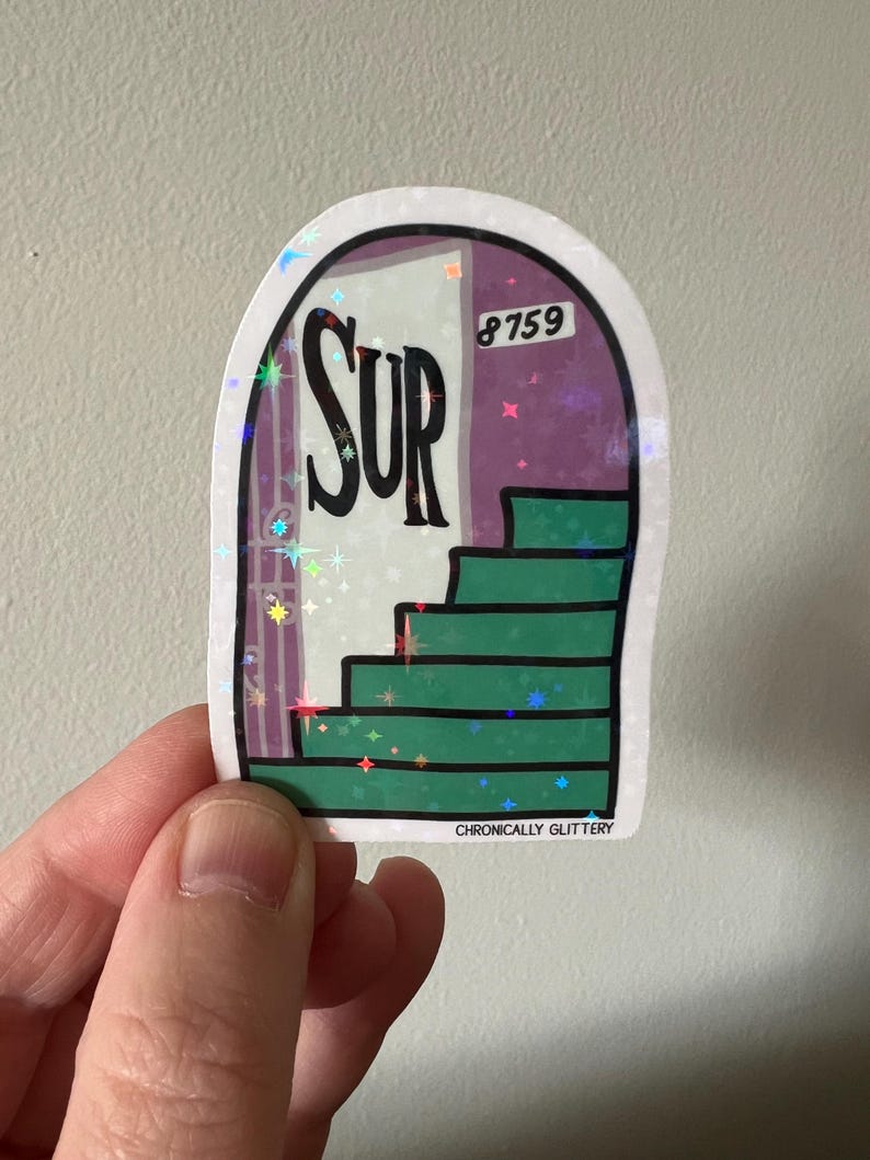 May include: A holographic sticker featuring a green staircase leading to a door with the word "SUR" and the number "8759" on it. The sticker has a glittery finish and says "Chronically Glittery" at the bottom.