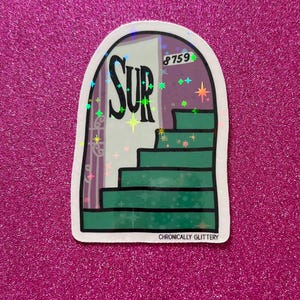 May include: A sticker with a holographic finish showing a green door with the word "SUP" on it. The door has a purple frame and the number "8759" on it. The door opens to a set of green stairs leading upwards. The sticker has the text "CHRONICALLY GLITTERY" at the bottom.