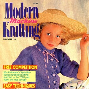 May include: A magazine cover featuring a young girl wearing a purple knitted sweater with pink ribbon accents and a straw hat. The magazine is titled "Modern Machine Knitting" and the cover text includes "Free Competition", "Easy Techniques", and "Fashion Knitwear".