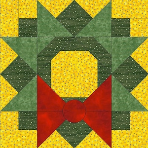 Może przedstawiać: Blok kołdry w kolorze zielonym i żółtym z czerwoną kokardą w środku. Kokarda ma duży czerwony okrąg w środku. Blok kołdry składa się z kwadratów i trójkątów.