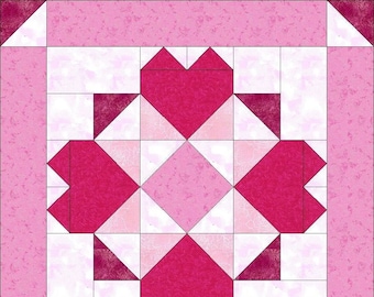 May include: A square quilt block featuring a central pink diamond surrounded by four dark pink heart shapes. The design is composed of various shades of pink and white fabric squares and triangles, framed by a solid pink border with white corner accents.
