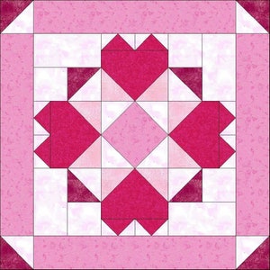 May include: A patchwork quilt block featuring a central design of four stylized hearts in varying shades of pink. The hearts are surrounded by white squares and triangles, all set against a pink patterned background. The block is square in shape.